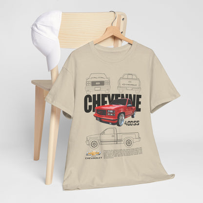 Chic setting featuring the Chevrolet Cheyenne Men's T-Shirt showcased on a wooden chair next to a white cap, emphasizing the bold graphic art of the classic red pickup truck.