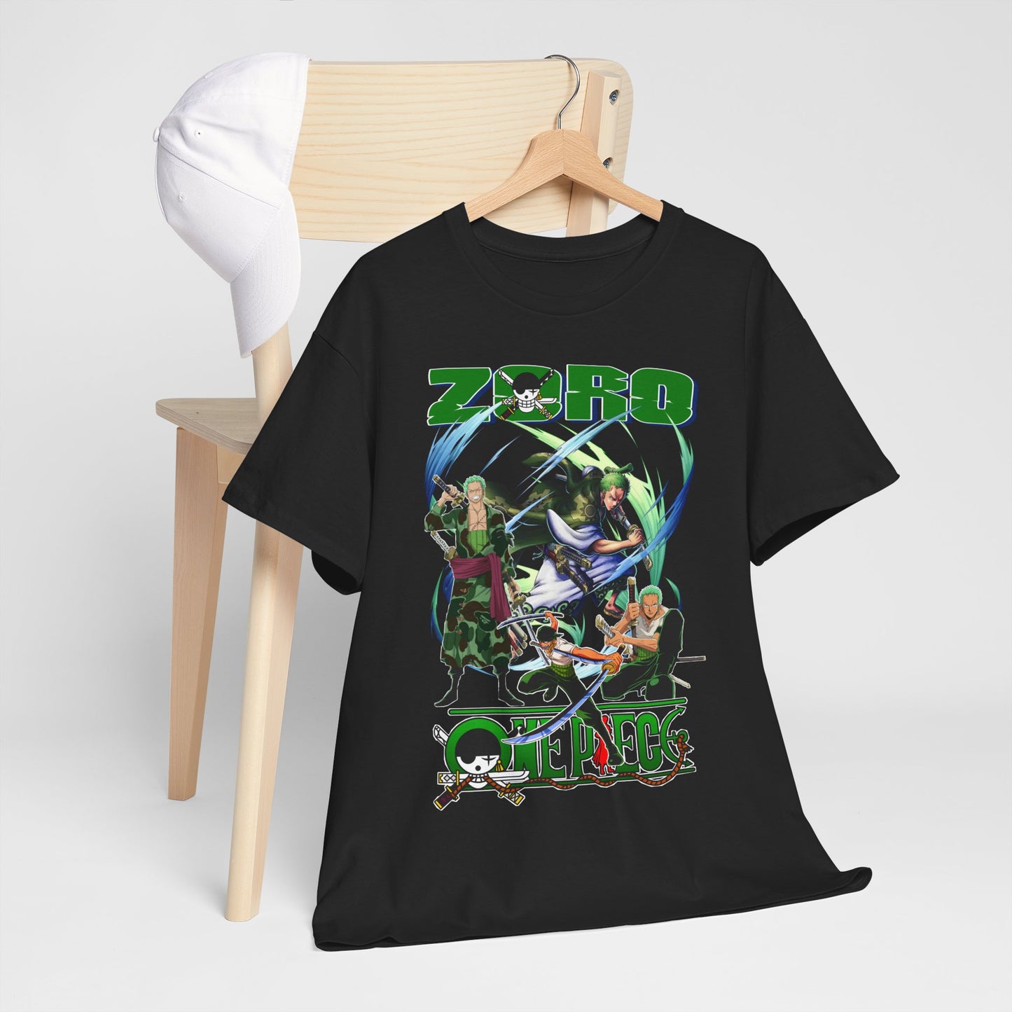 Black t-shirt draped over a chair alongside a white cap, featuring a vibrant design with Zoro, symbolising chic anime streetwear.