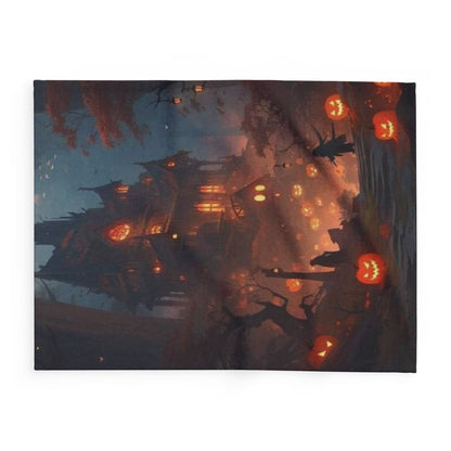 A stylish Halloween Arctic fleece blanket illustrating a ghostly home surrounded by glowing pumpkins, perfect for adding a luxurious touch to your Halloween decor.