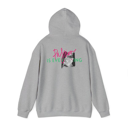 Stylish grey hoodie featuring a compelling back graphic of 'Passion IS EVERYTHING' in bold pink and green letters, enhanced by an elegant black and white portrait.