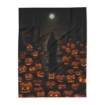 Decorative and Warm Halloween Spooky Arctic Fleece Blanket featuring a haunting scene of a cloaked figure amidst glowing jack-o'-lanterns under a full moon.