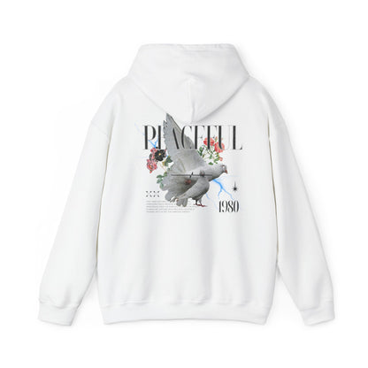 Stylish white hoodie featuring a serene dove and floral graphic, highlighted by the word 'PEACEFUL' and '1980', embodying a vintage aesthetic.