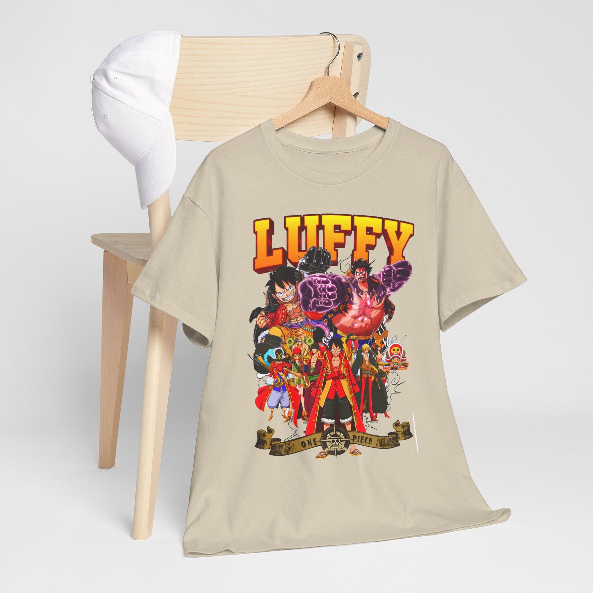 Luffy anime t-shirt showcased on a minimalistic chair next to a cap, representing a sophisticated blend of anime and casual elegance.
