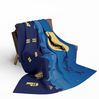 Luxurious Decorative and Warm Christmas Arctic Fleece Blanket elegantly draped on a stylish chair, featuring a stunning festive winter design with a moonlit night scene, perfect for enhancing your holiday decor.