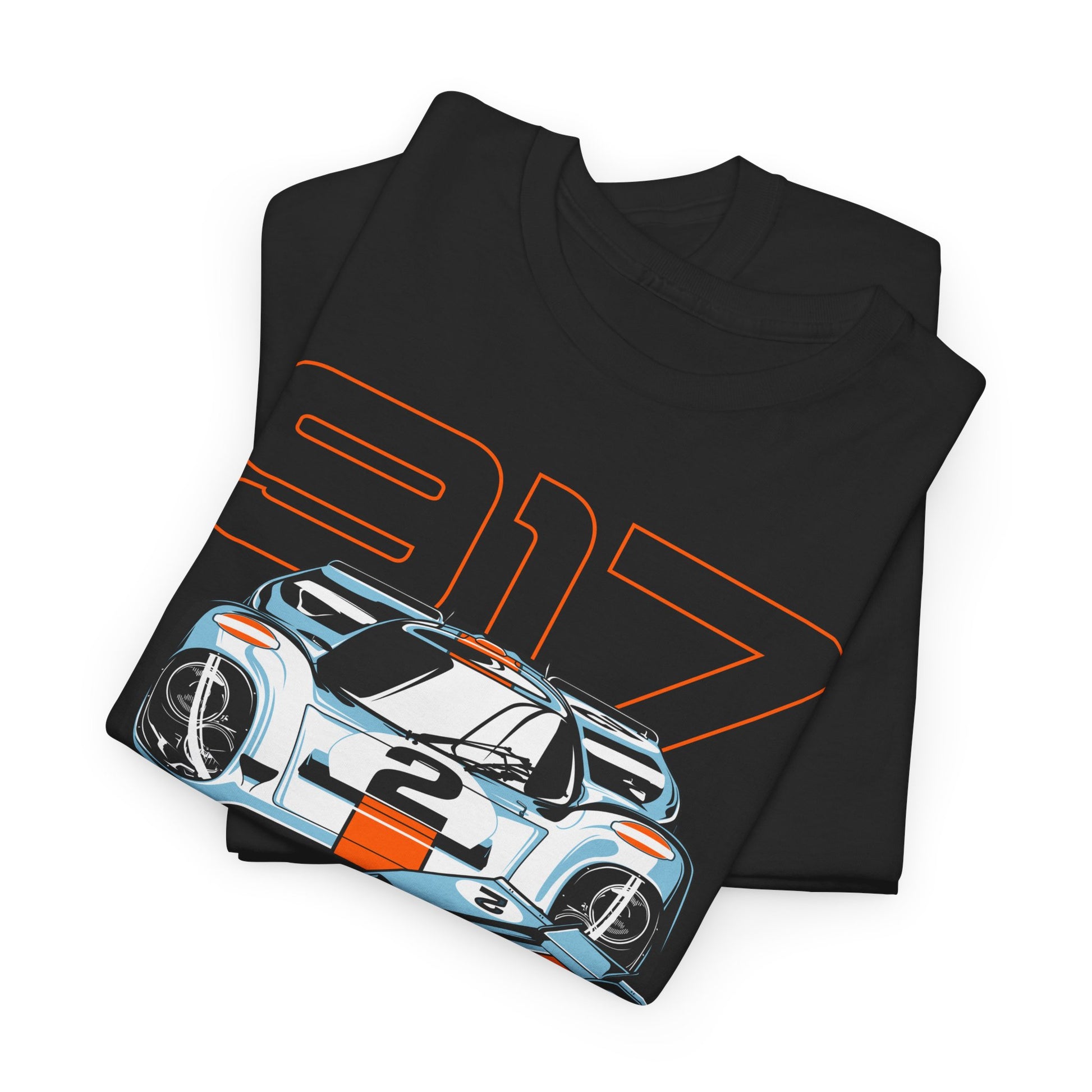 Folded black t-shirt with a striking Porsche 917 graphic, highlighting intricate detailing on legendary race cars, perfect for stylish car lovers.