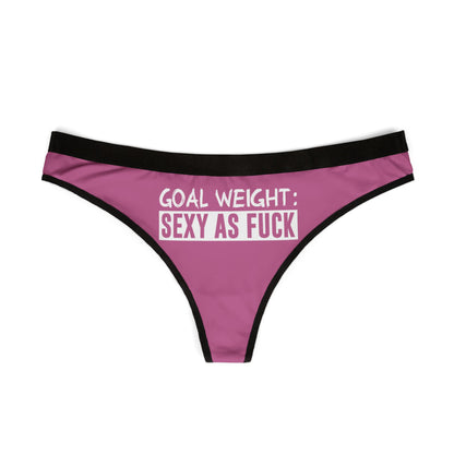 Chic pink thong with a black trim, prominently displaying the empowering phrase 'GOAL WEIGHT: SEXY AS F*CK', perfect for adding a cheeky touch to intimate apparel collections.