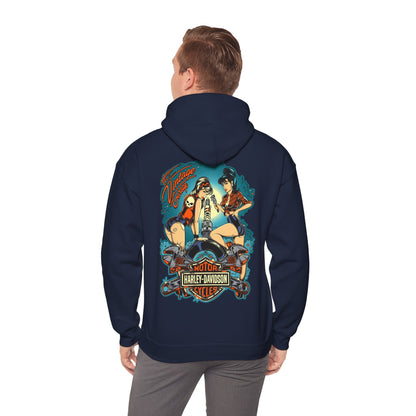 Stylish man wearing a navy hoodie with an artistic back print featuring two retro pin-up women working on a motorcycle, embodying classic vintage aesthetics.