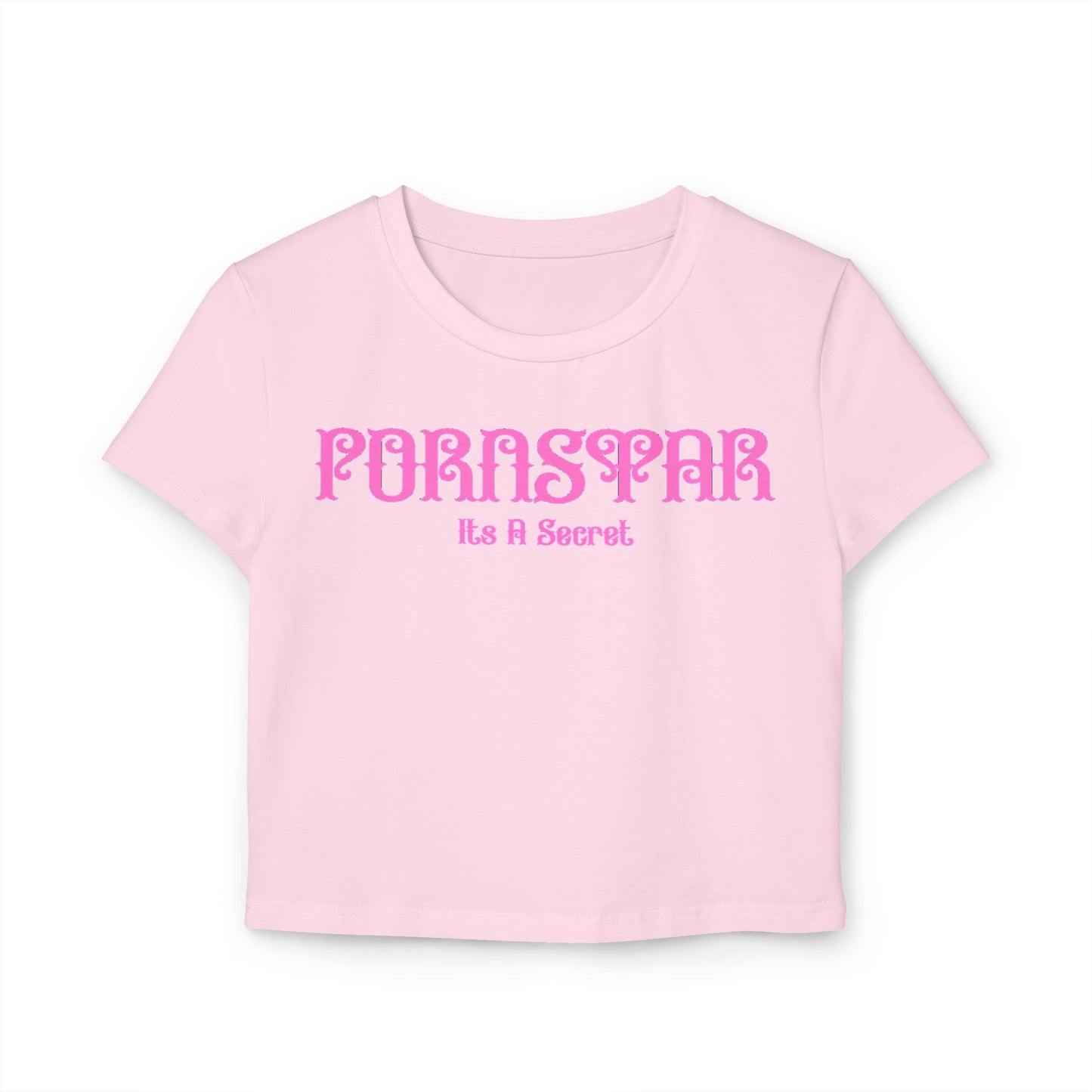 Elegant cropped t-shirt for women in soft pink featuring a playful vintage design with the words 'Pornstar' and 'It's A Secret' in stylised pink font, made from 100% organic cotton.
