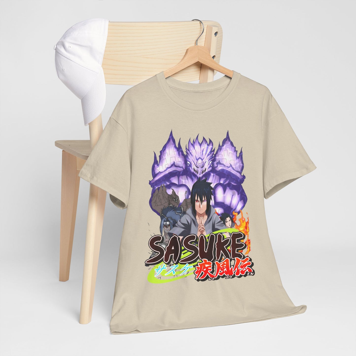 Elegant Sasuke Graphic Tee arranged on a chair alongside a cap, highlighting its unique design and versatile style for casual and trendy looks.