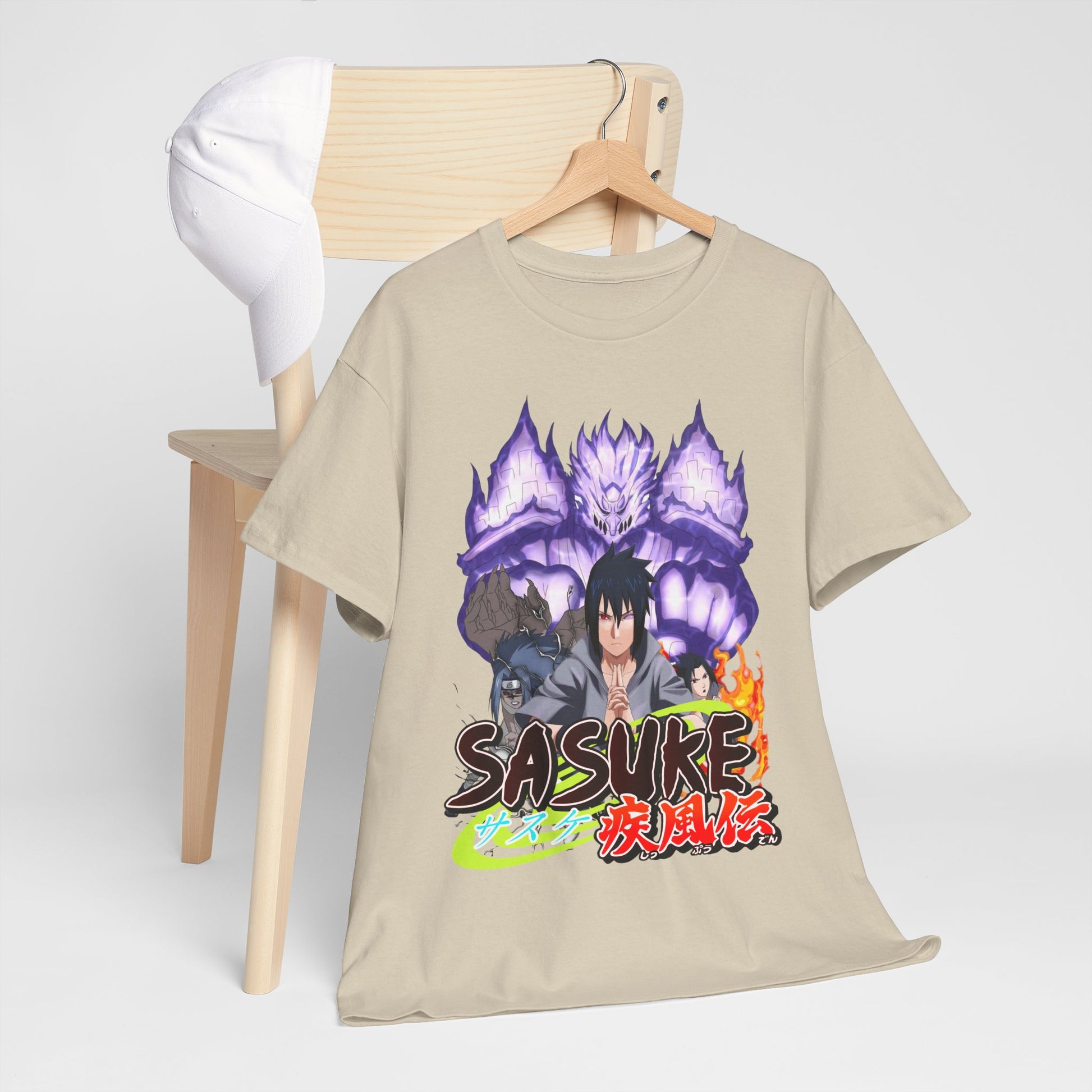 Elegant Sasuke Graphic Tee arranged on a chair alongside a cap, highlighting its unique design and versatile style for casual and trendy looks.