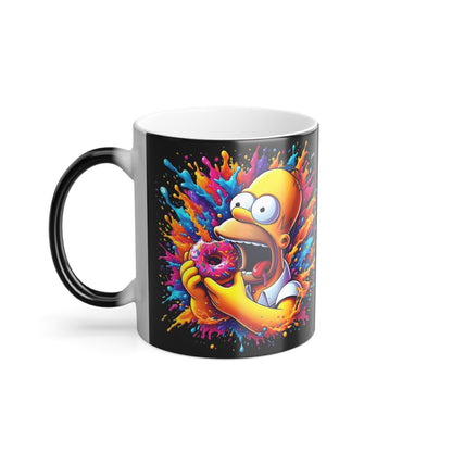Front view of the Homer Simpson 11oz Colour Morphing Mug displaying Homer enjoying his iconic donut amidst vibrant splashes, a luxurious addition to any Simpsons fan's collection.