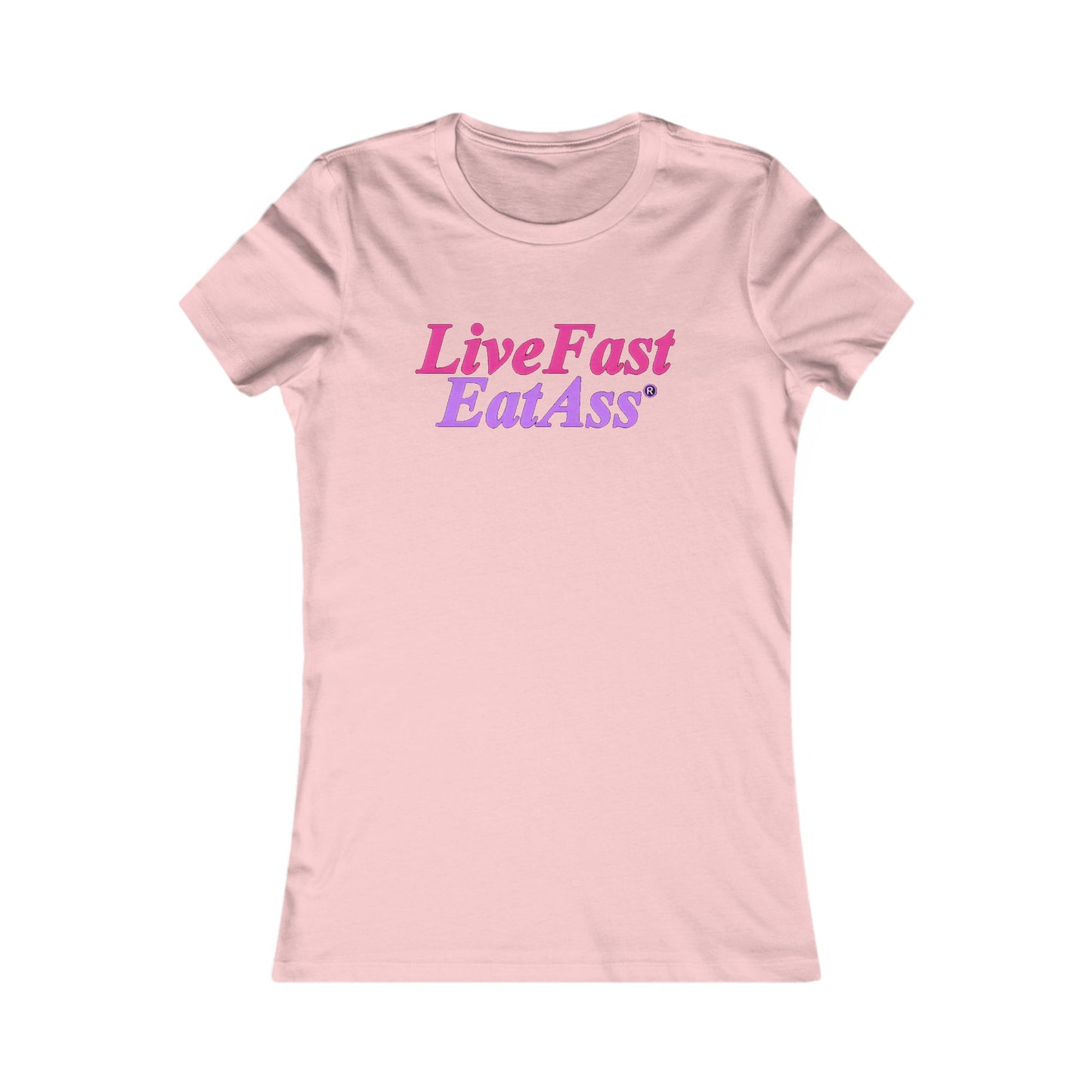 Delicate pink fitted women's t-shirt with the engaging phrase 'Live Fast, Eat Ass®' in a fashionable pink and purple gradient font, offering a playful touch to luxurious casual wear.