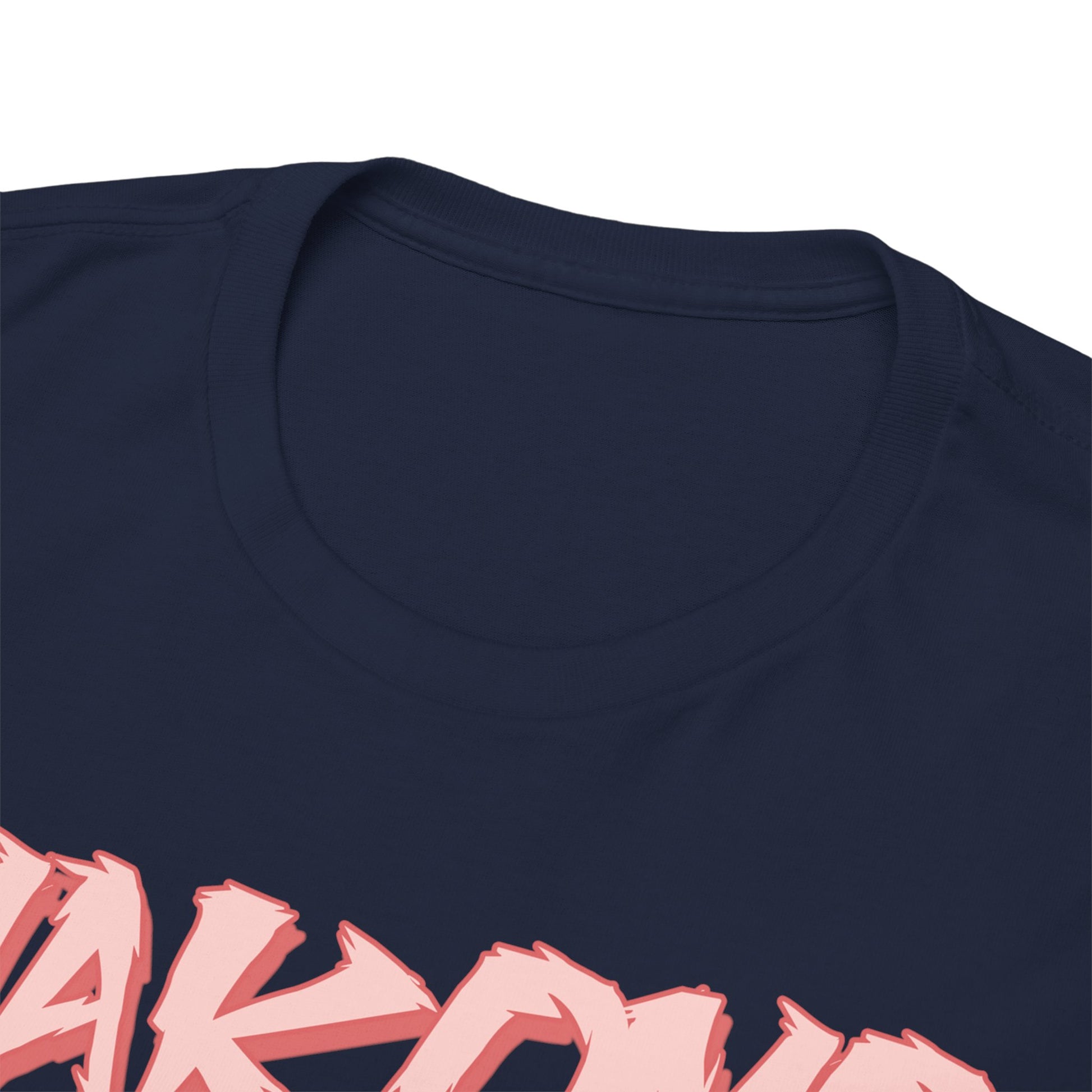 Close-up view of a premium navy blue T-shirt featuring bold pink "MAKOMO" text, showcasing superior fabric quality and craftsmanship.