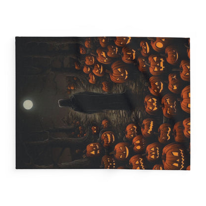 Decorative and Warm Halloween Spooky Arctic Fleece Blanket showcasing a mystical view of a cloaked figure standing surrounded by illuminated pumpkins beneath a moonlit sky.
