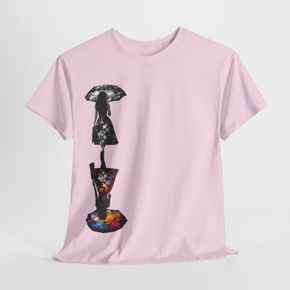 A luxurious Duality Dreams Unisex Graphic T-Shirt in soft pink, featuring an artistic floral design showcasing two silhouettes of women—one in black and white with a floral dress holding an umbrella, and the other in vibrant, multicoloured patterns, reflecting unique style and individual expression.