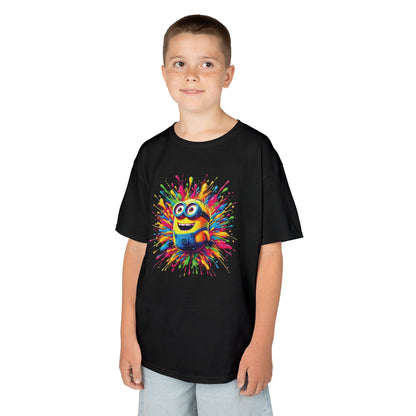 A smiling boy showcasing a Kids Minion Paint Splash T Shirt decorated with a joyful Minion character encircled by a colourful paint splash design. This Funny T Shirt is ideal for kids who love Minions.
