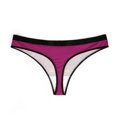 Stylish and cheeky pink thong designed for women, displaying the humorous text 'Kiss whoever the fuck you want' with a bright rainbow heart motif, perfect for adding a touch of fun to intimate apparel.