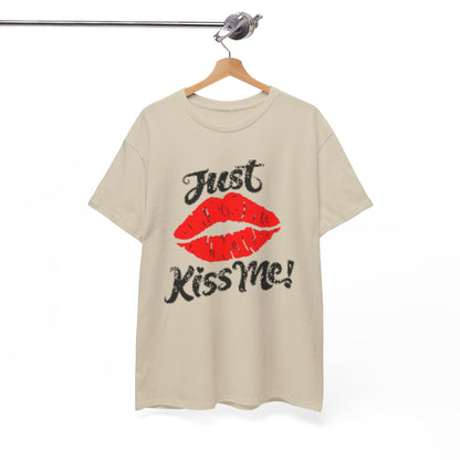 Sophisticated display of a beige unisex graphic t-shirt elegantly hanging, featuring an eye-catching print of red lips with the phrase 'Just Kiss Me!'.