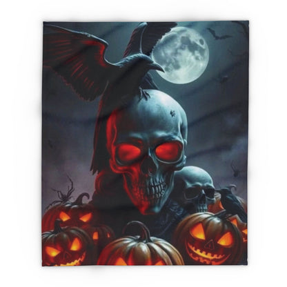 Stylish and cozy Halloween Arctic fleece blanket with a striking illustration of a skull surrounded by glowing jack-o'-lanterns and a raven under a moonlit sky, perfect for seasonal decor.