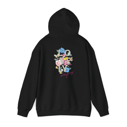 Chic black hoodie with floral artwork and cursive lettering on the rear, combining modern aesthetics and comfort for a refined look.