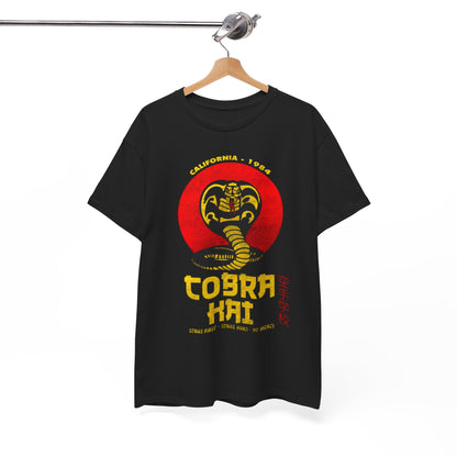 Chic black Cobra Kai T-shirt displayed on a hanger, featuring a dynamic snake logo and striking text 'Strike First - Strike Hard - No Mercy'. A luxurious statement piece for martial arts enthusiasts.