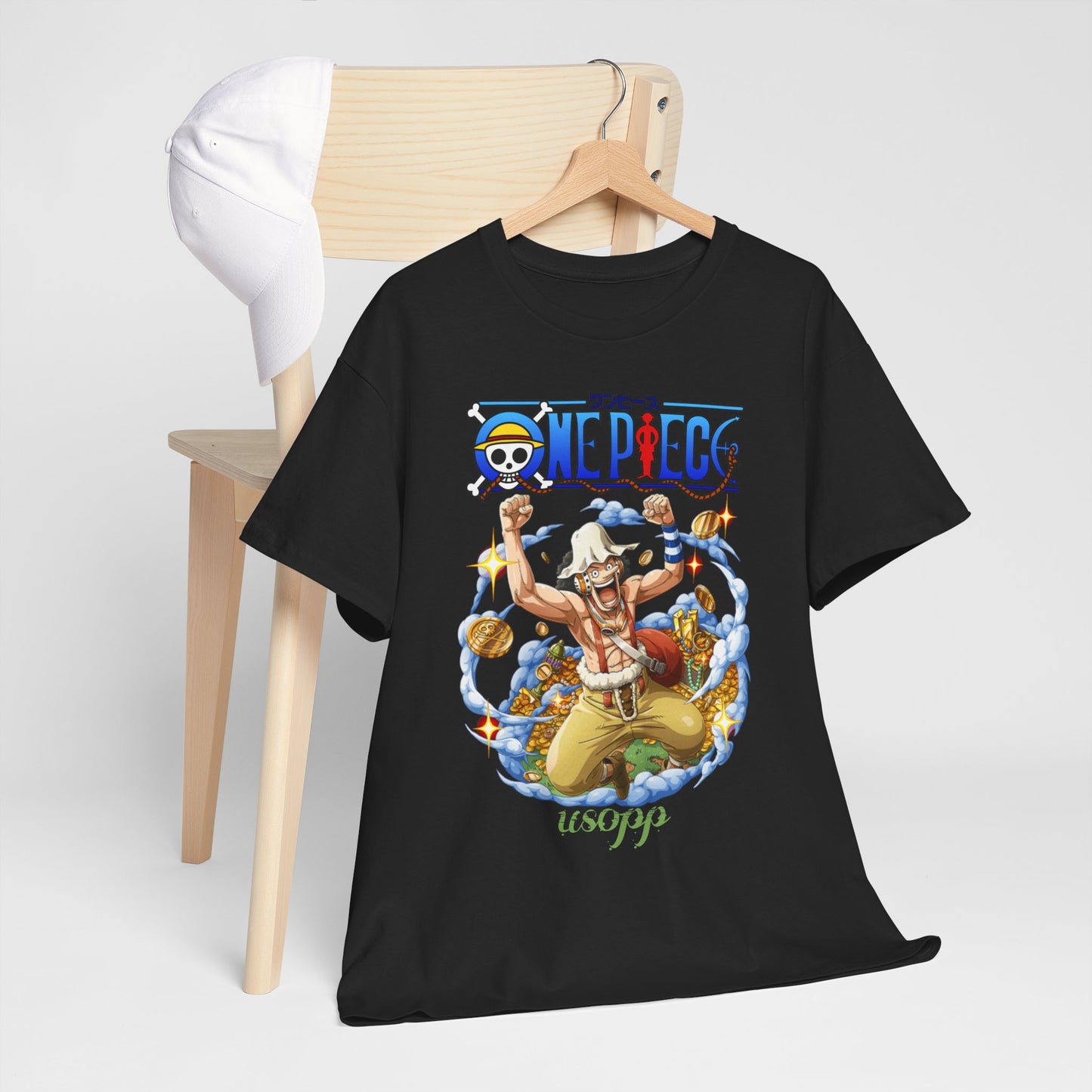 Elegant Dynamic Usopp Men's T-Shirt displayed on a wooden chair with a stylish white cap, featuring vibrant anime artwork that captures the essence of adventure in the popular series One Piece.