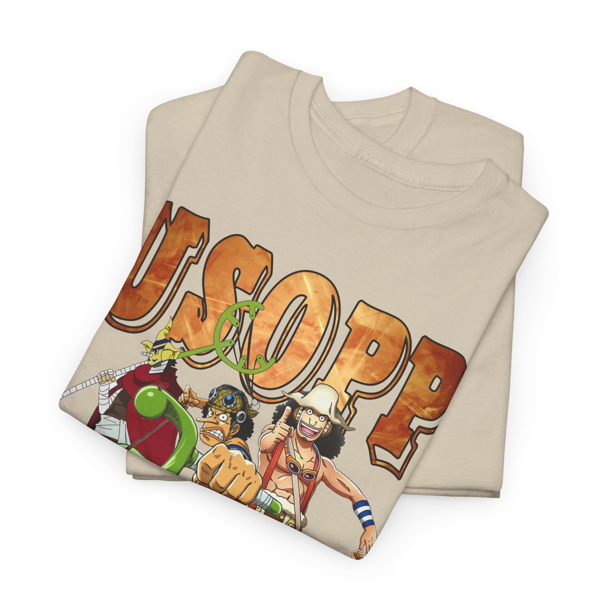 Close-up of a neatly folded beige t-shirt showcasing vibrant graphics of Usopp and companions, ideal for anime enthusiasts seeking stylish comfort.
