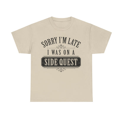 Elegant beige unisex T-shirt featuring the design 'Sorry I'm Late: I Was On A Side Quest' in bold typography, perfect for adding a whimsical touch to any wardrobe.
