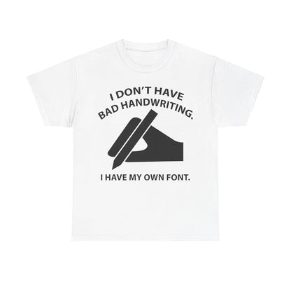 Chic white graphic unisex t-shirt showcasing the quote 'I DON'T HAVE BAD HANDWRITING. I HAVE MY OWN FONT.' alongside an artistic hand design, a fashionable choice for those with a unique sense of style.