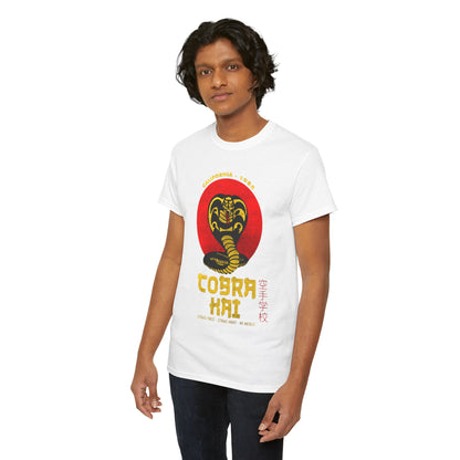 Elegant unisex Cobra Kai t-shirt in pristine white, featuring a striking cobra design, modelled by a handsome young man with flowing hair, perfect for martial arts enthusiasts.