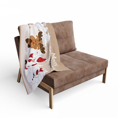 Luxurious Decorative and Warm Christmas Arctic Fleece Blanket draped over a stylish armchair, featuring festive designs of gingerbread men and snowmen, perfect for holiday gatherings.