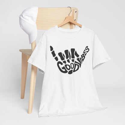 Elegant men's t-shirt with a striking skeletal hand design, featuring the phrase 'GOOD VIBES', expertly displayed on a wooden hanger next to a stylish cap.