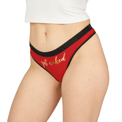 Chic red thong with a sumptuous gold 'get naked' print, accentuated by a refined black waistband, perfect for playful romantic occasions.