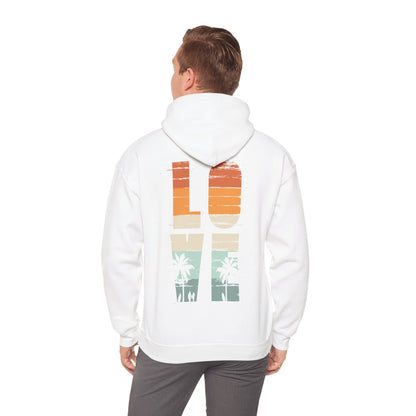 Charming model wearing the Vintage Love Hoodie in white, presenting the iconic back graphic with a sunset-inspired palette, epitomising modern fashion meets nostalgic flair.