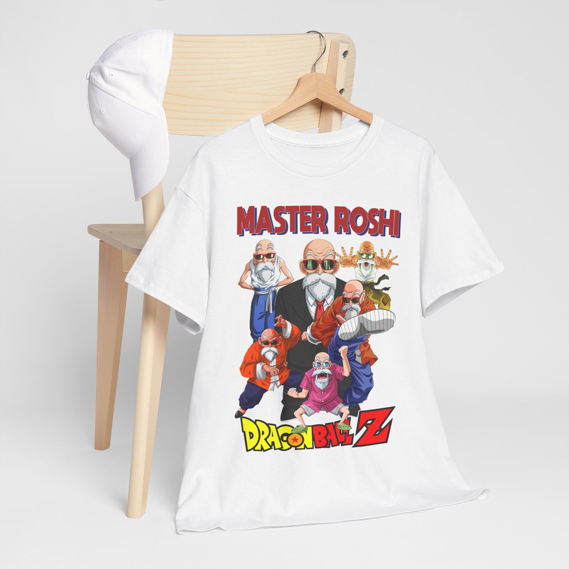 Chic white T-shirt featuring Master Roshi from Dragon Ball Z, artistically styled with vibrant graphics, draped over a wooden chair alongside a minimalist cap, perfect for sophisticated anime fashion.