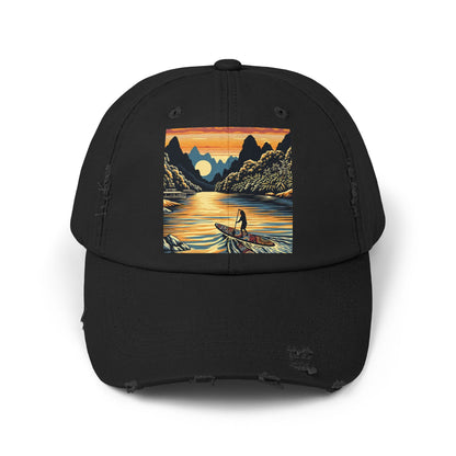 Unisex Distressed Paddleboarders Cap featuring a luxurious fantasy design, perfect for stylish water adventures. The cap showcases an artistic depiction of a paddleboarder gliding across serene waters, framed by lush mountains and a glowing sunset.