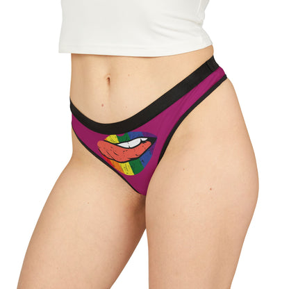 Stylish women's thong modelled on a figure, featuring a bold lip graphic on pink fabric, an ideal blend of humour and allure.
