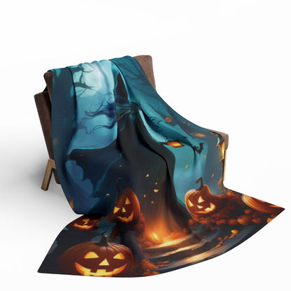 Luxury Decorative and Warm Halloween Spooky Arctic Fleece Blanket draped elegantly over a chair, featuring a haunting Halloween scene with jack-o'-lanterns and glowing lights, perfect for enhancing your festive décor.