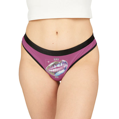 Luxury women's thong featuring a holographic design of plump, glossy lips with the text 'EAT ME', set against a soft pink background for an enticing look.