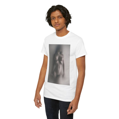 Confident male model wearing a white t-shirt adorned with a striking blurred graphic of a nude figure, representing contemporary art and distinctive fashion.