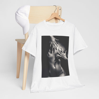 Luxury graphic t-shirt featuring an abstract design of hands on a smooth torso, artistically displayed on a minimalist wooden chair with a white cap, symbolising elegance and intrigue.