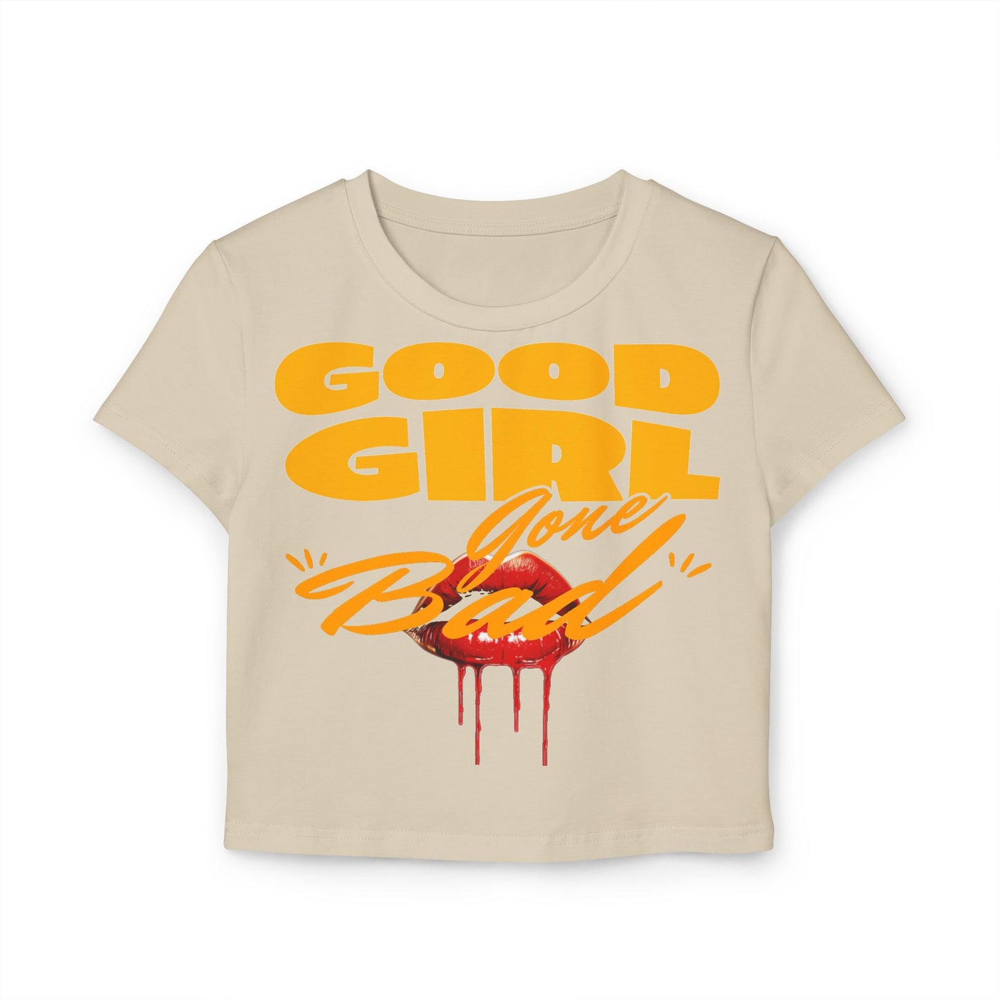Elegant cropped women's t-shirt in cream featuring the daring 'Good Girl Gone Bad' statement and vibrant red lips graphic, perfect for a chic look.