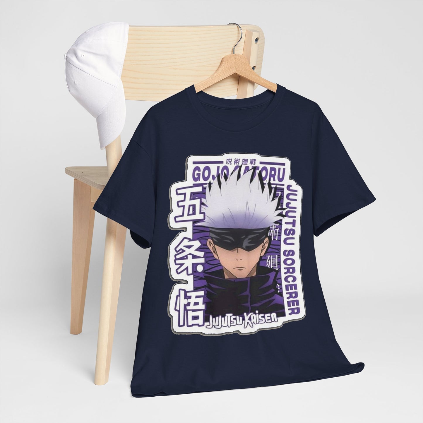 Gojo Satoru T-shirt draped over a modern chair alongside a cap, highlighting its trendy design and versatility in fashion, suitable for any anime lover.