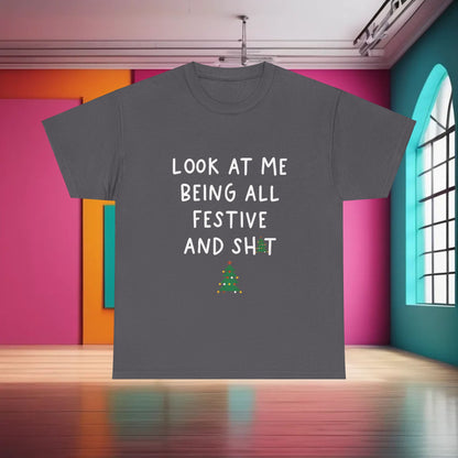 Sarcasm Xmas Christmas Graphic T-Shirt featuring the phrase 'LOOK AT ME BEING ALL FESTIVE AND SH*T' in stylish typography, displayed in a vibrant indoor setting.