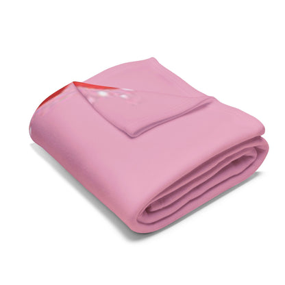 Folded Decorative and Warm Christmas Arctic Fleece Blanket presenting a soft pink surface with a delightful 'Merry Christmas' motif, perfect for cozy winter evenings.