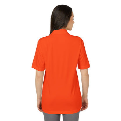 Back view of the Adidas Unisex Performance Polo Shirt in vibrant orange, made from 100% recycled polyester, providing UPF 50+ protection and excellent breathability.