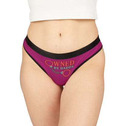 Luxurious cheeky women's thong in vibrant pink with playful handcuff design and 'Owned By Daddy' print, perfect for adding a touch of fun to romantic occasions.