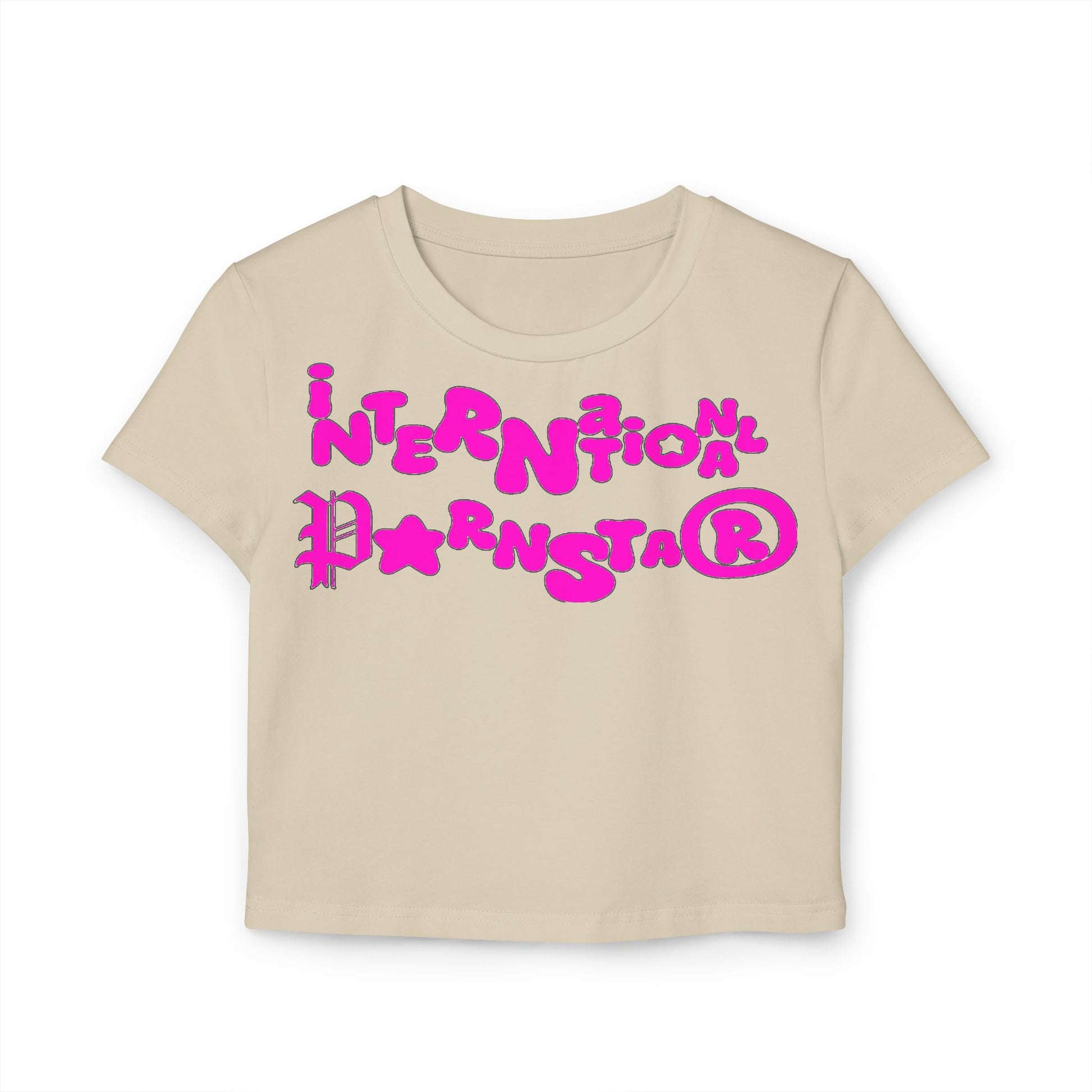 Elegant casual women's crop t-shirt in soft beige showcasing a whimsical 'International Star' design in bold pink, ideal for versatile styling.