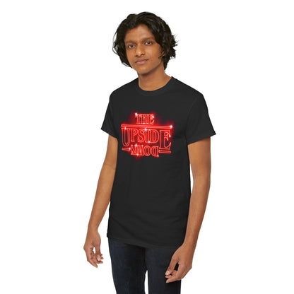 Sophisticated black graphic t-shirt adorned with the bold 'THE UPSIDE DOWN' design in striking red, worn by a stylish young man leaning confidently.