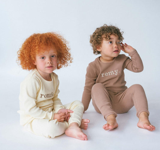 Elegant family wearing DreamBuy matching Christmas pyjamas set, showcasing soft ribbed lounge wear for all sizes from 3M to XXL.